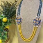 Collana artigianale con medaglioni double-face raffiguranti Limoni e fantasie geometriche, doppio colore giallo e acquamarina. Collane caratteristiche siciliane