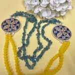 Collana artigianale con medaglioni double-face raffiguranti Limoni e fantasie geometriche, doppio colore giallo e acquamarina. Collane caratteristiche siciliane